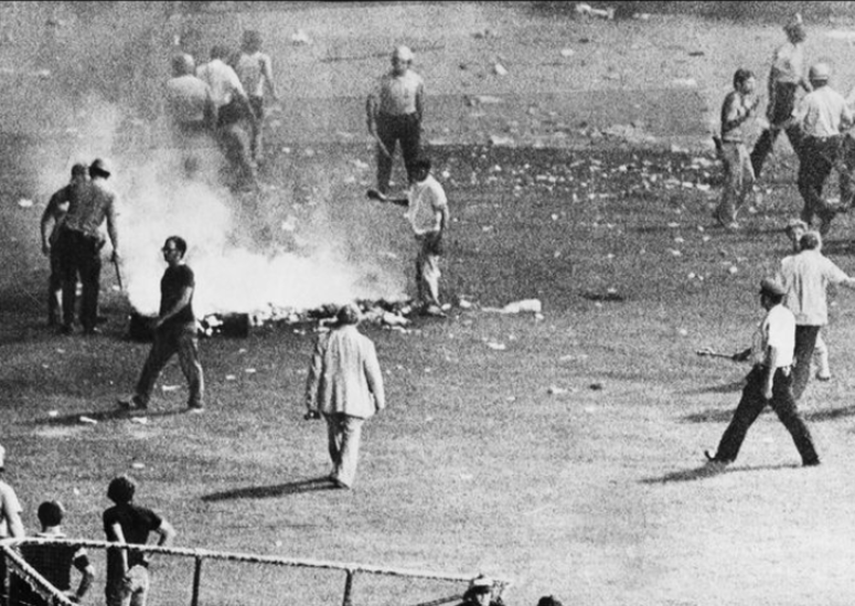 Chicago police disperse the crowd in center field at Comiskey Park after hundreds of disco records were blown up. Chicago police disperse the crowd in center field at Comiskey Park after hundreds of disco records were blown up.