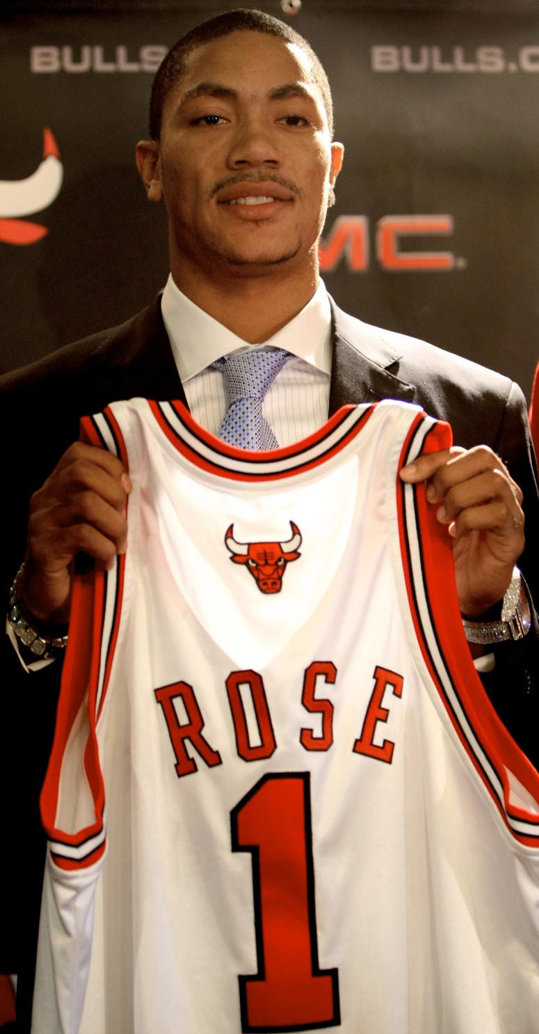 Chicago Bulls draft pick Derrick Rose holds up his Bulls jersey at a press conference at the United Center on Monday, June 30, 2008