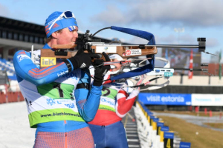 OTEPAA, ESTONIA – MARCH 12, 2017: Yuri Shopping of Russia (front) and Kristoffer Skjevik of Norway (back) competes during the final single mixed relay of IBU Cup 2016/2017 in Otepaa, Estonia. IBU biathlon Cup final stage was held in Otepaa, Estonia on Mar