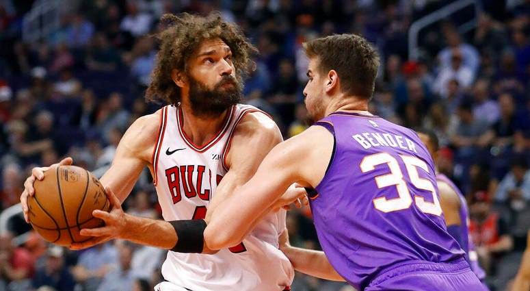 Chicago Bulls center Robin Lopez looks to shoot over Phoenix Suns forward Dragan Bender (35) during the second half of an NBA basketball game, Monday, March 18, 2019, in Phoenix. Chicago Bulls center Robin Lopez looks to shoot over Phoenix Suns forward Dragan Bender (35) during the second half of an NBA basketball game, Monday, March 18, 2019, in Phoenix.