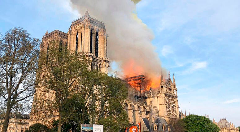 Notre Dame cathedral is burning in Paris, Monday, April 15, 2019. Massive plumes of yellow brown smoke is filling the air above Notre Dame Cathedral and ash is falling on tourists and others around the island that marks the center of Paris. Notre Dame cathedral is burning in Paris, Monday, April 15, 2019. Massive plumes of yellow brown smoke is filling the air above Notre Dame Cathedral and ash is falling on tourists and others around the island that marks the center of Paris.