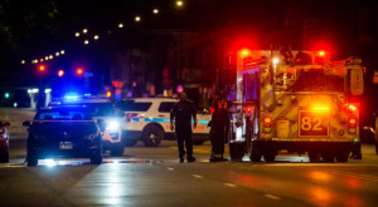 A Chicago Fire Fighter looks at a shot up vehicle which was involved in a shoot out with an off-duty police officer, Saturday morning in the Burnside neighborhood. A Chicago Fire Fighter looks at a shot up vehicle which was involved in a shoot out with an off-duty police officer, Saturday morning in the Burnside neighborhood.