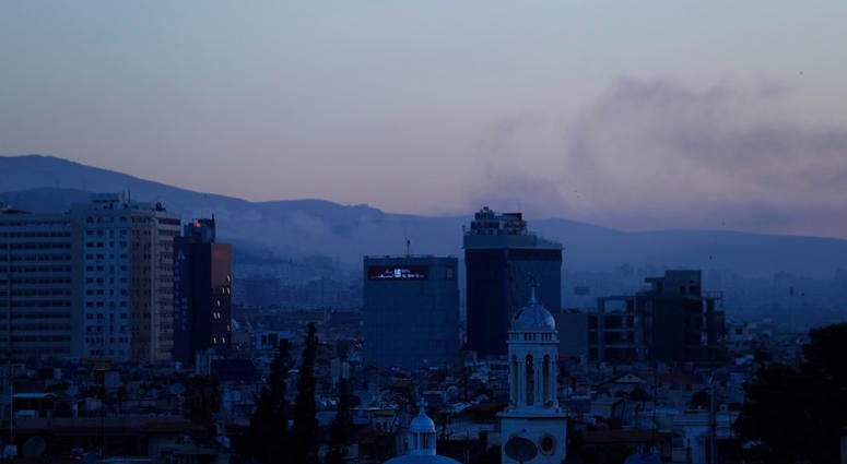Syrian air strikes Smoke rises after airstrikes targeting different parts of the Syrian capital Damascus, Syria, early Saturday, April 14, 2018. Syria's capital has been rocked by loud explosions that lit up the sky with heavy smoke.