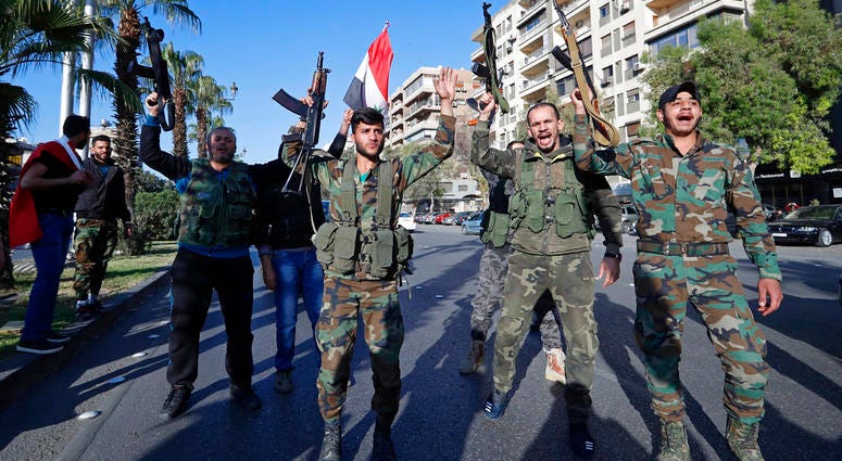 Syrian soldiers Syrian soldiers hold their weapons as they dance and chant slogans against U.S. President Trump during demonstrations following a wave of U.S., British and French military strikes to punish President Bashar Assad for suspected chemical attack against civi