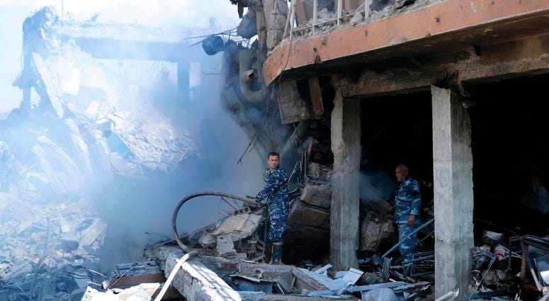 Syrian firefighters Firefighters extinguish smoke that rises from the damage of the Syrian Scientific Research Center which was attacked by U.S., British and French military strikes to punish President Bashar Assad for suspected chemical attack against civilians, in Barzeh.
