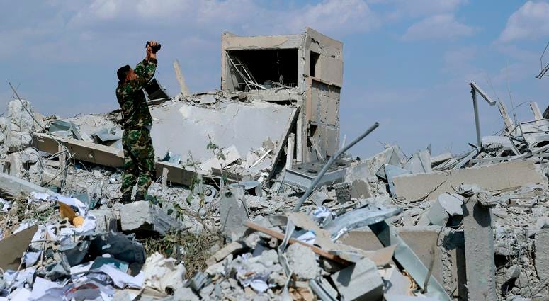 Syrian soldier films the damage of the Syrian Scientific Research Center A Syrian soldier films the damage of the Syrian Scientific Research Center which was attacked by U.S., British and French military strikes to punish President Bashar Assad for suspected chemical attack against civilians, in Barzeh, near Damascus, Syria, S