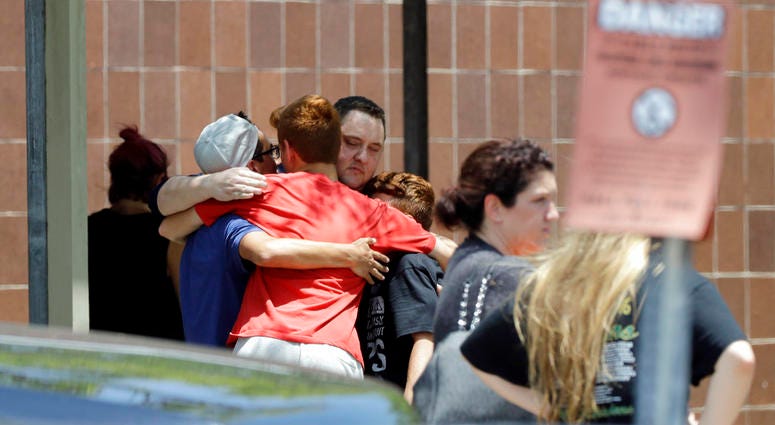 People react outside the unification center at the Alamo Gym, following a shooting at Santa Fe High School Friday, May 18, 2018, in Santa Fe, Texas. People react outside the unification center at the Alamo Gym, following a shooting at Santa Fe High School Friday, May 18, 2018, in Santa Fe, Texas.