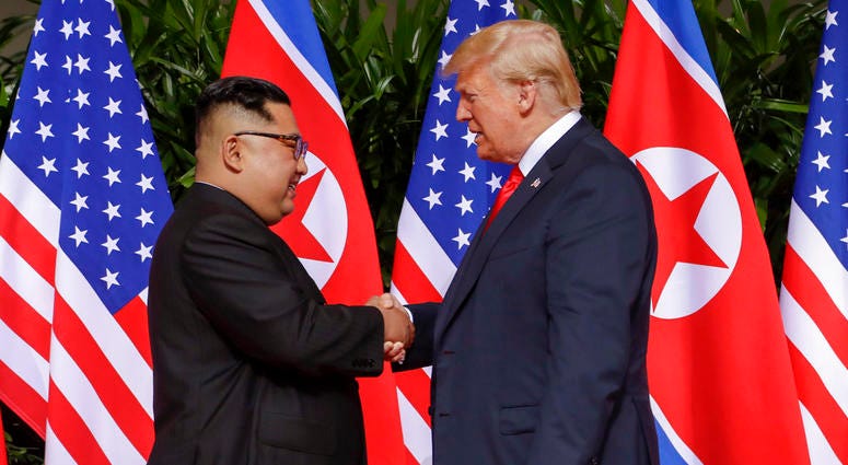 U.S. President Donald Trump shakes hands with North Korea leader Kim Jong Un at the Capella resort on Sentosa Island Tuesday, June 12, 2018 in Singapore.