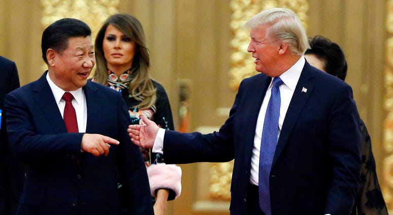 U.S. President Donald Trump and China's President Xi Jinping arrive for the state dinner with the first ladies at the Great Hall of the People in Beijing, China.