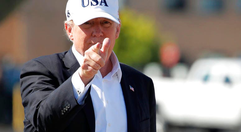 President Donald Trump points before boarding Air Force One at Morristown Municipal Airport, in Morristown, N.J., Sunday, July 8, 2018, en route to Washington from Trump National Golf Club in Bedminster, N.J. (AP Photo/Carolyn Kaster)