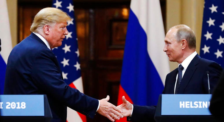 U.S. President Donald Trump shakes hand with Russian President Vladimir Putin at the end of the press conference after their meeting at the Presidential Palace in Helsinki, Finland, Monday, July 16, 2018.