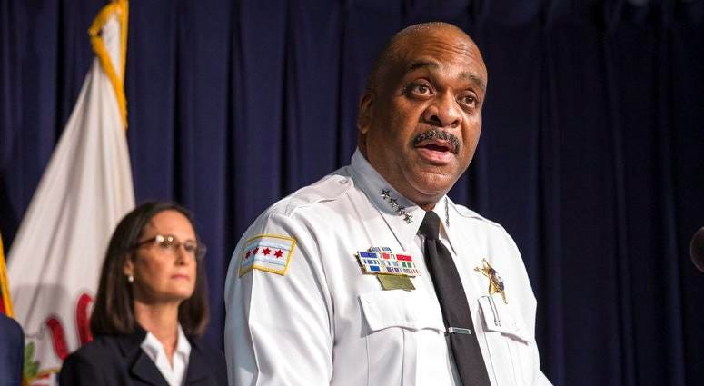 In this Aug. 29, 2018 file photo, Chicago Police Superintendent Eddie Johnson, accompanied by Illinois Attorney General Lisa Madigan, center, and Chicago Mayor Rahm Emanuel, speaks at a news conference in Chicago. The city of Chicago says it has agreed t
