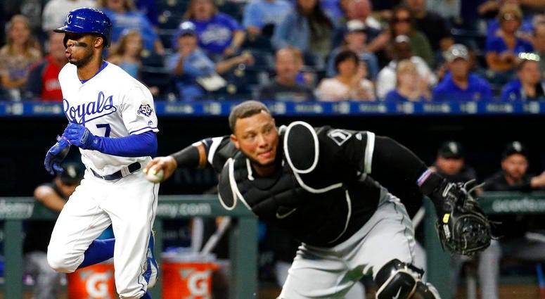 Chicago White Sox catcher Welington Castillo throws to first after fielding a single bunt by Kansas City Royals' Adalberto Mondesi while Rosell Herrera (7) scores during the third inning of a baseball game, Tuesday, Sept. 11, 2018, in Kansas City, Mo.