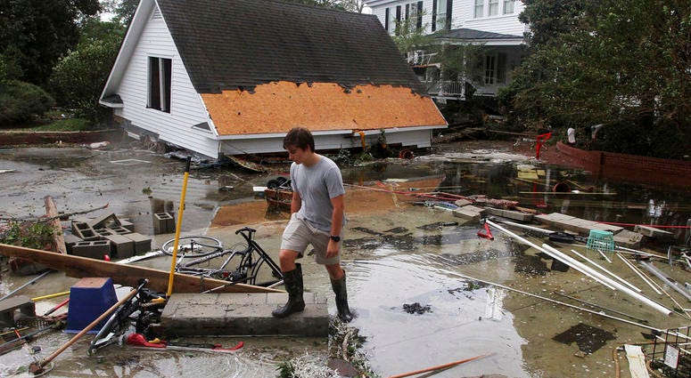 Resident Joseph Eudi looks at flood debris and storm damage from Hurricane Florence at a home on East Front Street in New Bern, N.C., Saturday, Sept. 15, 2018. (Gray Whitley/Sun Journal via AP) Resident Joseph Eudi looks at flood debris and storm damage from Hurricane Florence at a home on East Front Street in New Bern, N.C., Saturday, Sept. 15, 2018. (Gray Whitley/Sun Journal via AP)