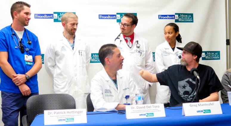 Greg Manteufel, right, thanks medical staff at Froedtert & the Medical College of Wisconsin on Tuesday, Oct.2, 2018, in Milwaukee. Manteufel spoke about his recovery from a rare blood infection that led to the amputation of part of his forearms and legs.