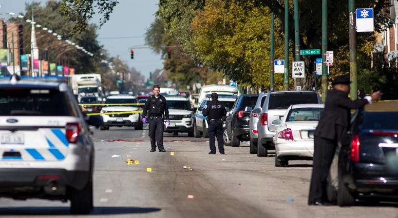 In this Monday, Oct. 22, 2018 photo, Chicago Police investigate following a shooting after a funeral service in Chicago. Police scrambled Tuesday to ward off retaliatory attacks by street gangs after a Chicago rapper known for taunting rivals on social me In this Monday, Oct. 22, 2018 photo, Chicago Police investigate following a shooting after a funeral service in Chicago. Police scrambled Tuesday to ward off retaliatory attacks by street gangs after a Chicago rapper known for taunting rivals on social me