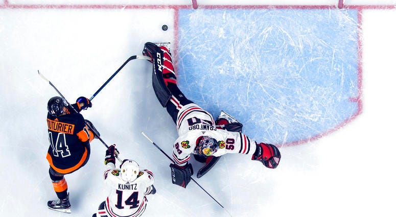 Philadelphia Flyers' Sean Couturier, left, shoots the puck past Chicago Blackhawks' Corey Crawford, right, for a goal with Chris Kunitz, center, defending during the second period of an NHL hockey game, Saturday, Nov. 10, 2018, in Philadelphia. (AP Photo/ Philadelphia Flyers' Sean Couturier, left, shoots the puck past Chicago Blackhawks' Corey Crawford, right, for a goal with Chris Kunitz, center, defending during the second period of an NHL hockey game, Saturday, Nov. 10, 2018, in Philadelphia. (AP Photo/