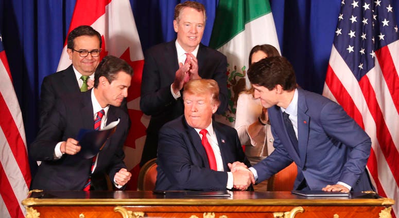 President Donald Trump, center, shakes hands with Canada's Prime Minister Justin Trudeau as Mexico's President Enrique Pena Nieto looks on after they signed a new United States-Mexico-Canada Agreement that is replacing the NAFTA trade deal, during a cerem President Donald Trump, center, shakes hands with Canada's Prime Minister Justin Trudeau as Mexico's President Enrique Pena Nieto looks on after they signed a new United States-Mexico-Canada Agreement that is replacing the NAFTA trade deal, during a cerem