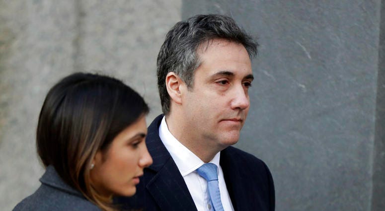 Michael Cohen, right, President Donald Trump's former lawyer, arrives at federal court for his sentencing for dodging taxes, lying to Congress and violating campaign finance laws in New York on Wednesday, Dec. 12, 2018. (
