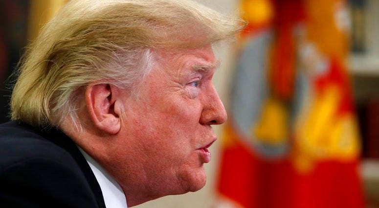 President Donald Trump speaks to members of the five branches of the military by video conference on Christmas Day, Tuesday, Dec. 25, 2018, in the Oval Office of the White House.