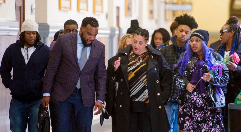 Rose family attorney, S. Lee Merritt, left, and Michelle Kenney, center, mother of Antwon Rose II, walk towards members of the media following the closing arguments.