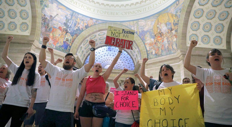 Abortion-rights activists react after lawmakers approved a sweeping piece of anti-abortion legislation, a bill that would ban most abortions in the state of Missouri, Friday, May 17, 2019 in Jefferson, Mo. If enacted, the ban would be among the most restr