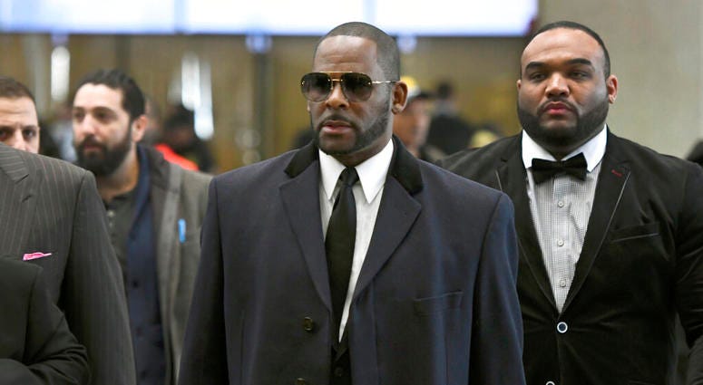 Musician R. Kelly, center, arrives at the Leighton Criminal Court building for a hearing in Chicago. Musician R. Kelly, center, arrives at the Leighton Criminal Court building for a hearing in Chicago.