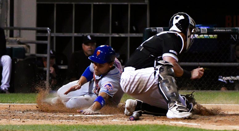 New York Mets' Michael Conforto, left, scores past Chicago White Sox catcher James McCann during the sixth inning of a baseball game Wednesday, July 31, 2019, in Chicago. New York Mets' Michael Conforto, left, scores past Chicago White Sox catcher James McCann during the sixth inning of a baseball game Wednesday, July 31, 2019, in Chicago.