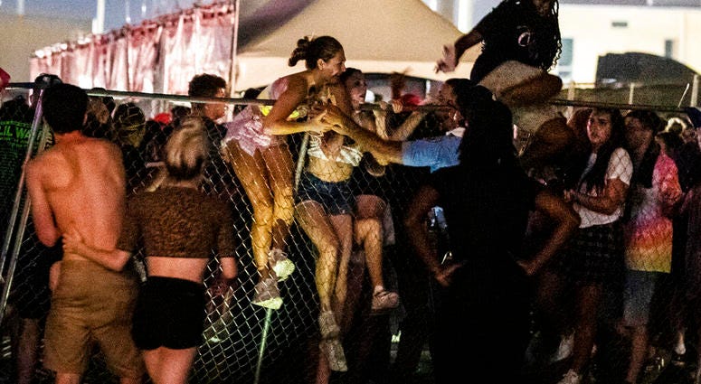 Festival-goers try to escape the crowd during Lil Wayne's fifth annual Lil WeezyAna Fest at the UNO Lakefront Arena grounds in New Orleans. Festival-goers try to escape the crowd during Lil Wayne's fifth annual Lil WeezyAna Fest at the UNO Lakefront Arena grounds in New Orleans.