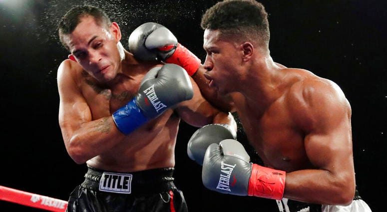 In this Oct. 27, 2018, file photo, Patrick Day, right, punches Elvin Ayala during the fifth round of a WBC super welterweight boxing bout in New York. In this Oct. 27, 2018, file photo, Patrick Day, right, punches Elvin Ayala during the fifth round of a WBC super welterweight boxing bout in New York.