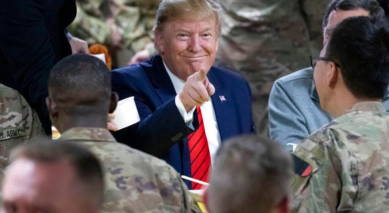 President Donald Trump speaks with members of the military during a surprise Thanksgiving Day visit, Thursday, Nov. 28, 2019, at Bagram Air Field, Afghanistan.