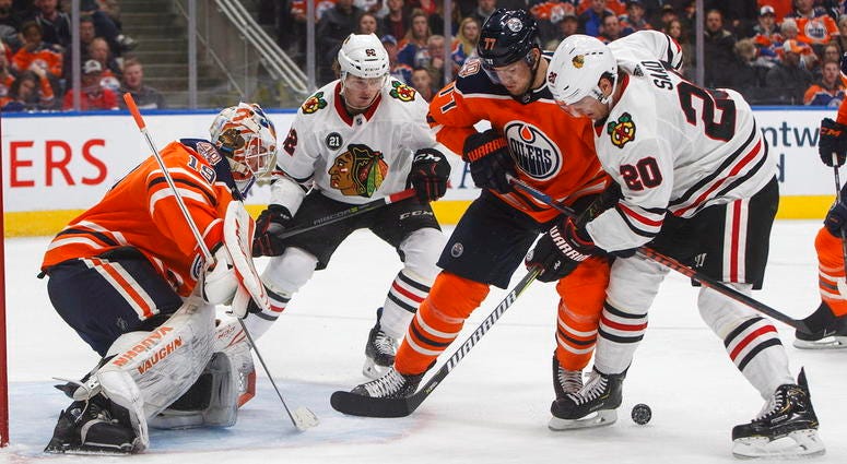 Chicago Blackhawks' Brandon Saad (20) and Edmonton Oilers' Oscar Klefbom (77) battle for the rebound from Edmonton Oilers' goalie Mikko Koskinen (19) as Luke Johnson (62) skates in during third period NHL hockey action in Edmonton, Alberta, on Thursday. Chicago Blackhawks' Brandon Saad (20) and Edmonton Oilers' Oscar Klefbom (77) battle for the rebound from Edmonton Oilers' goalie Mikko Koskinen (19) as Luke Johnson (62) skates in during third period NHL hockey action in Edmonton, Alberta.