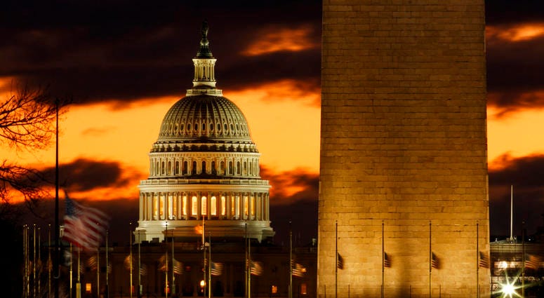 The U.S. Capitol dome is seen past the base of the Washington Monument just before sunrise in Washington, Saturday, Dec. 22, 2018. The U.S. Capitol dome is seen past the base of the Washington Monument just before sunrise in Washington, Saturday, Dec. 22, 2018.