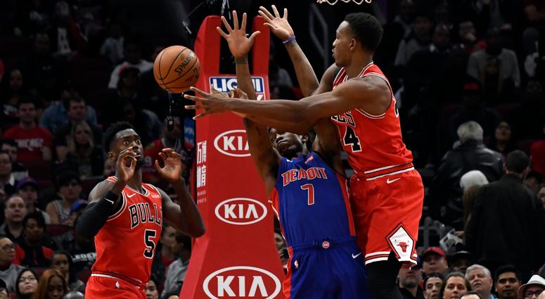 Bulls center Wendell Carter Jr. (34) passes the ball to forward Bobby Portis (5) as Pistons forward Stanley Johnson (7) defends. Bulls center Wendell Carter Jr. (34) passes the ball to forward Bobby Portis (5) as Pistons forward Stanley Johnson (7) defends.
