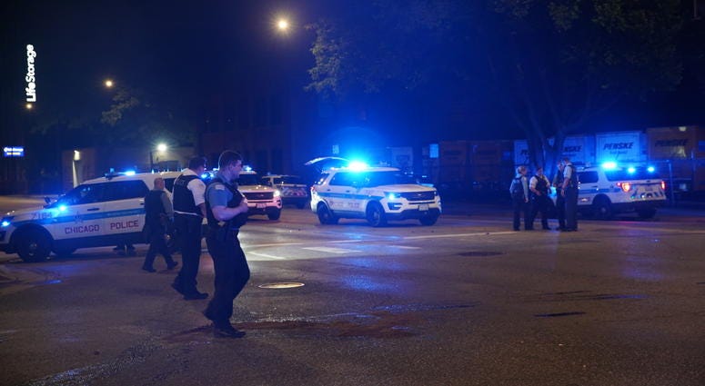 Chicago police gather at the intersection of Western Avenue and Fulton Street, where a police vehicle was rear-ended June 25, 2019. Chicago police gather at the intersection of Western Avenue and Fulton Street, where a police vehicle was rear-ended June 25, 2019.
