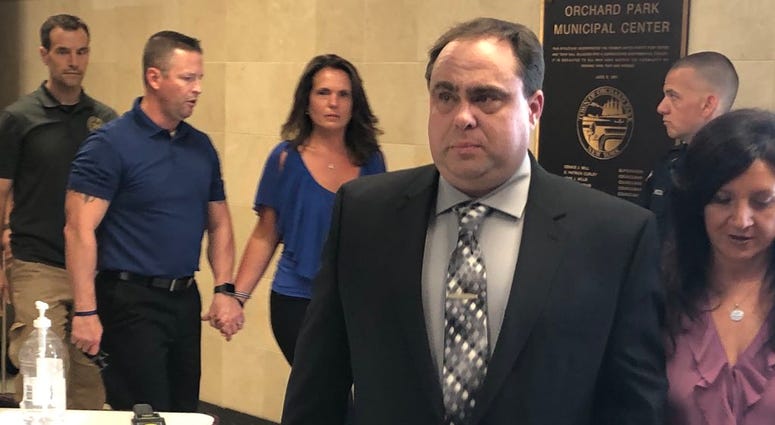 Erie County Sheriff's Deputy Ken Achtyl walks out of Orchard Park courthouse after being arraigned on four charges