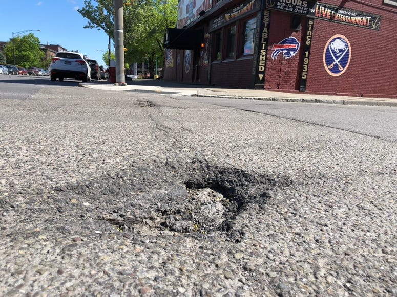 Potholes along Main Street near the Anchor Bar. May 21, 2019 (WBEN Photo/Mike Baggerman)