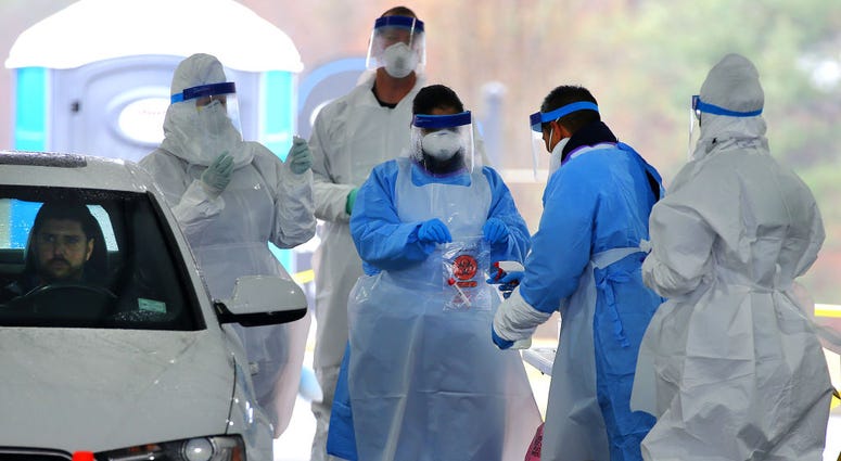 SHREWSBURY, MA - MARCH 19: Medical take a patient's coronavirus test during a trial run for a new FEMA drive-thru coronavirus testing clinic at CVS at 720 Boston Turnpike in Shrewsbury, MA on March 19, 2020. The clinic had a tent on Route 9 and was waitin SHREWSBURY, MA - MARCH 19: Medical take a patient's coronavirus test during a trial run for a new FEMA drive-thru coronavirus testing clinic at CVS at 720 Boston Turnpike in Shrewsbury, MA on March 19, 2020. The clinic had a tent on Route 9 and was waitin