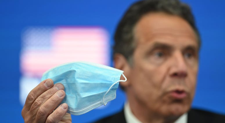 Governor Andrew Cuomo demonstrates a face mask