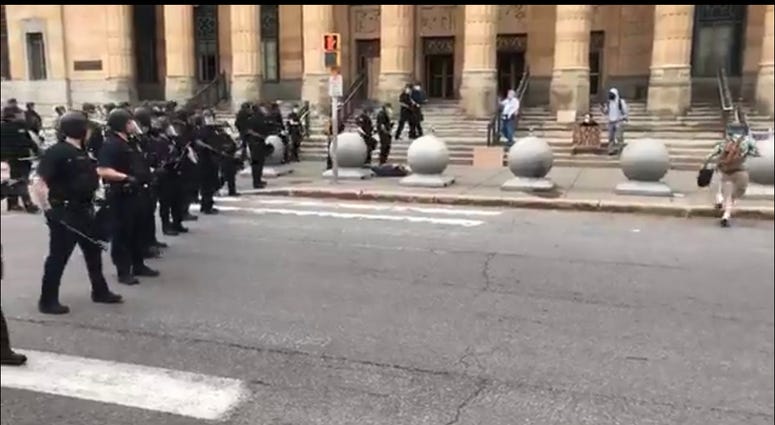 Man pushed to the ground by police officers