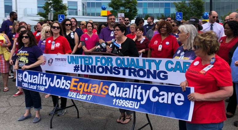 Healthcare professionals gather outside Oishei Children's Hospital to discuss contract negotiations with Kaleida