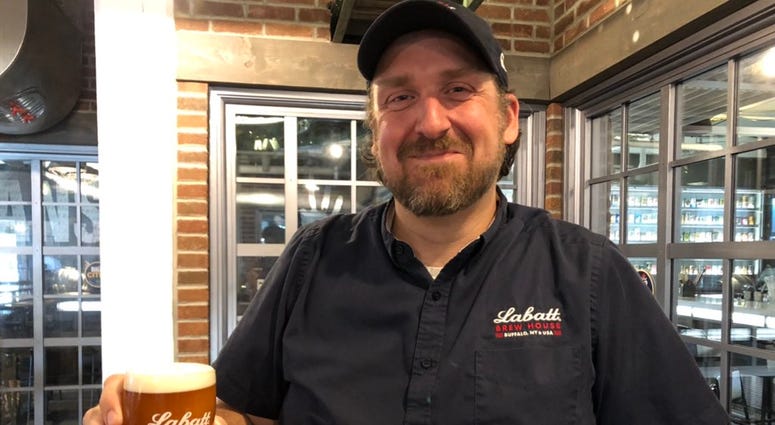 Ryan Brady shows off Labatt Blue and Gold Ale