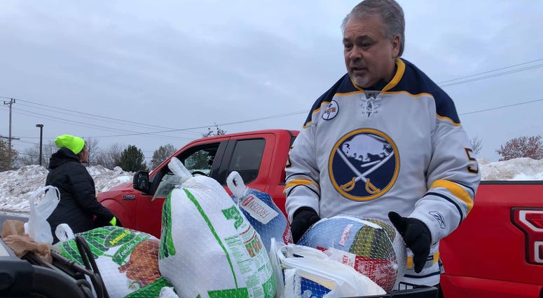 Craig Muni from the Buffalo Sabres volunteers in the 2019 Turkeys for Tickets drive. November 20, 2019 (WBEN Photo/Mike Baggerman)