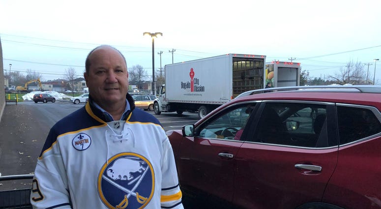 Derek Smith from the Buffalo Sabres volunteers at Turkeys for Tickets. November 20, 2019 (WBEN Photo/Mike Baggerman)