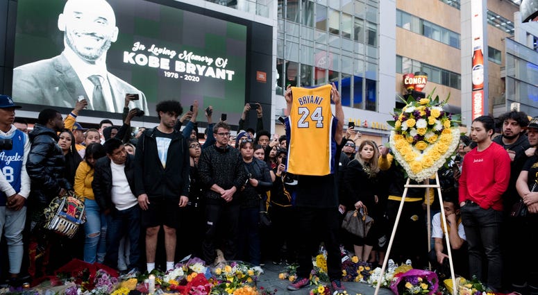 Fans gather at L.A. Live in Los Angeles to pay their respects to former Los Angeles Lakers guard Kobe Bryant who died in helicopter crash on Sunday