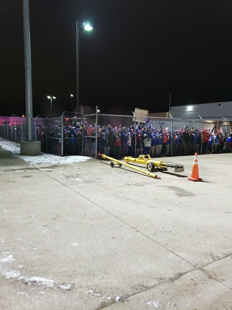 Buffalo Bills fans line fence at airport
