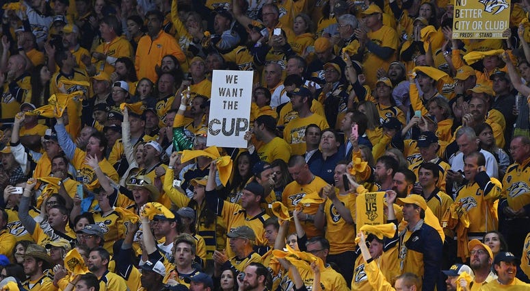 Nashville Predators fans cheer and hold signs. Jun 5, 2017; Nashville, TN, USA; Nashville Predators fans cheer and hold signs for the Stanley Cup in game four of the 2017 Stanley Cup Final at Bridgestone Arena.