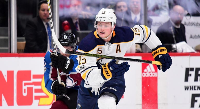 Dec 5, 2017; Denver, CO, USA; Buffalo Sabres center Jack Eichel (15) shoots and scores an empty net goal as Colorado Avalanche center Alexander Kerfoot (13) chases down from behind in the third period at the Pepsi Center. Dec 5, 2017; Denver, CO, USA; Buffalo Sabres center Jack Eichel (15) shoots and scores an empty net goal as Colorado Avalanche center Alexander Kerfoot (13) chases down from behind in the third period at the Pepsi Center.