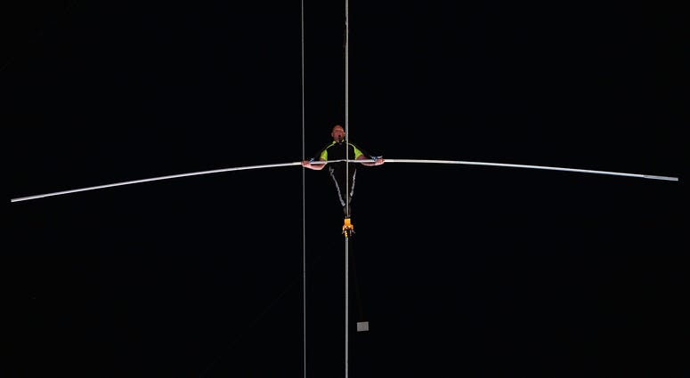 Arialist Nick Wallenda walks on a high wire across Times Square in New York