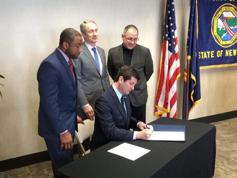 Mark Poloncarz signs an executive order to create a website ranking area nursing homes. The website will be available on Monday. (WBEN Photo/Mike Baggerman)